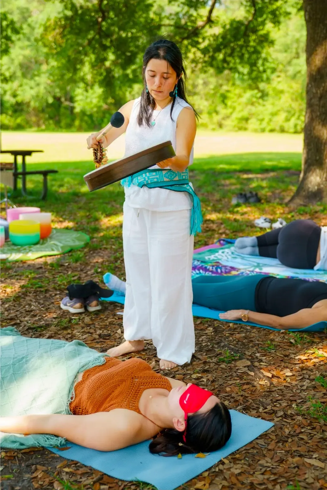 Group sound bath outdoors in a park